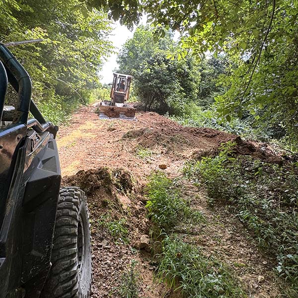 Cleaning ATV trails with a bulldozer.