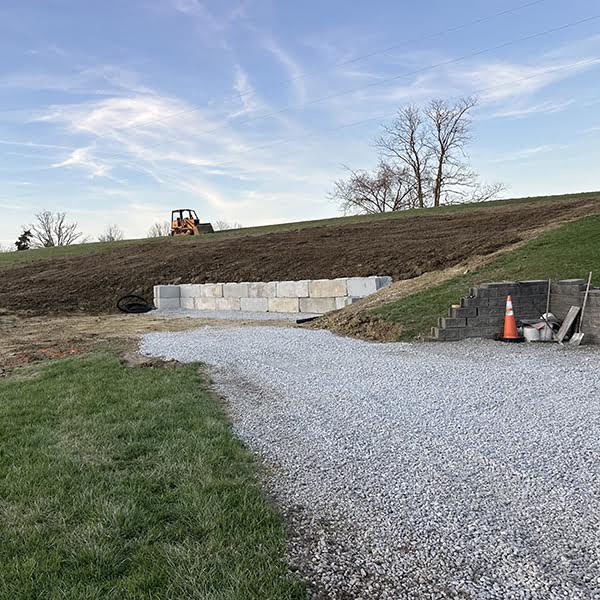 Excavated garage pad with retaining wall.